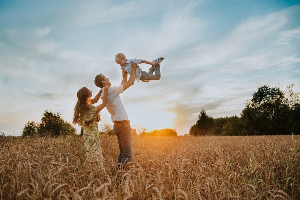 Family fun on field at sunset